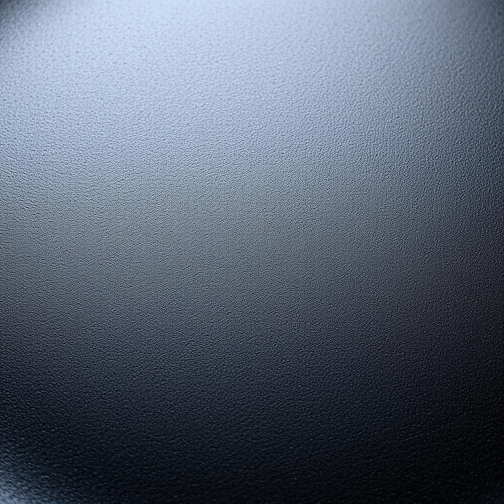 Close-up of carbon steel griddle pan surface showing blue-black patina in 2025